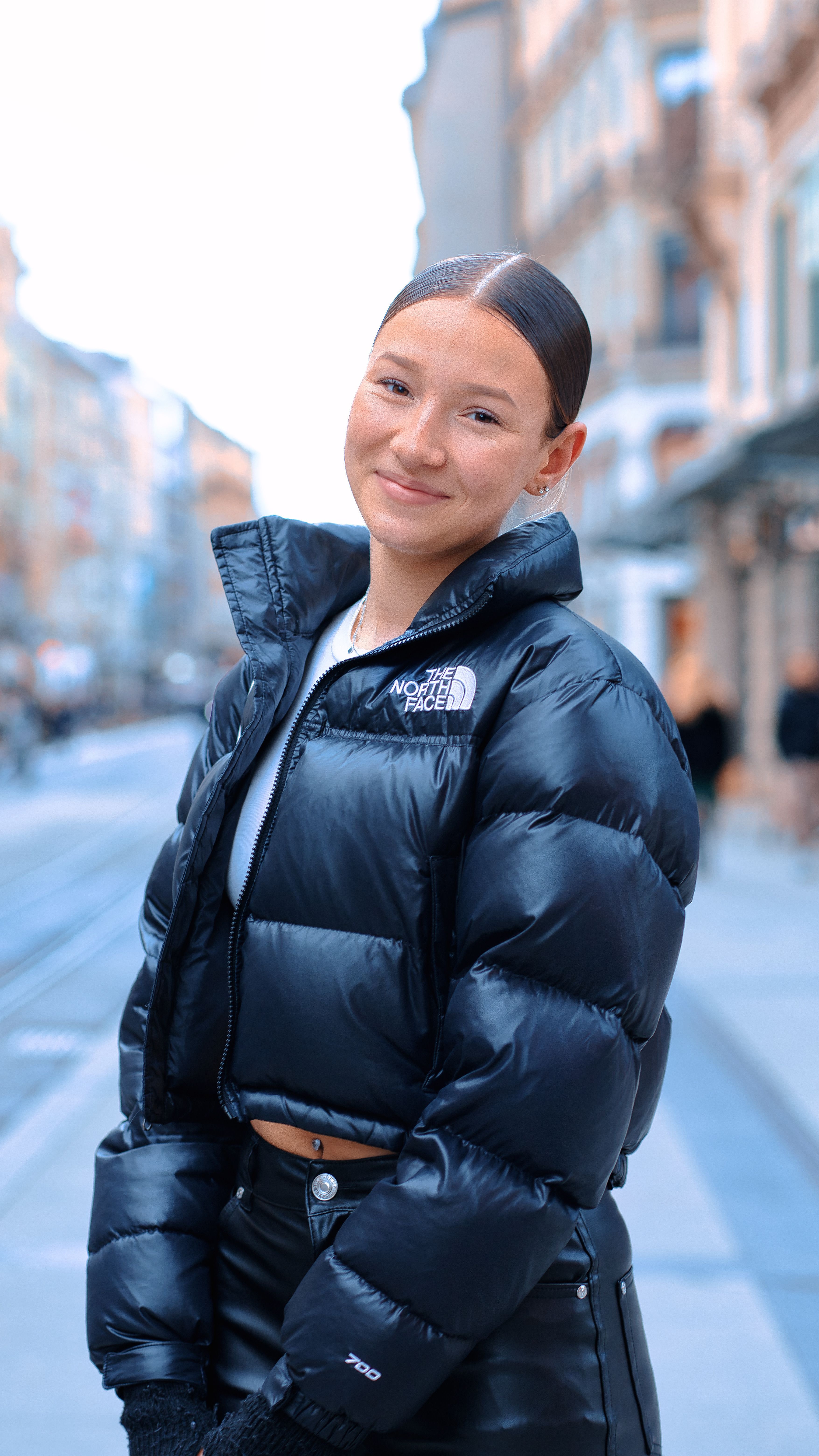 Young Woman in a Jacket Standing on the Street in City and Smiling ...