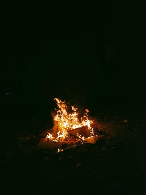 Free A blazing campfire illuminates the darkness, showcasing vivid flames and warmth. Stock Photo