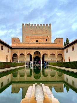 Stunning view of Alhambra Palace with reflection pool in Granada, Spain.