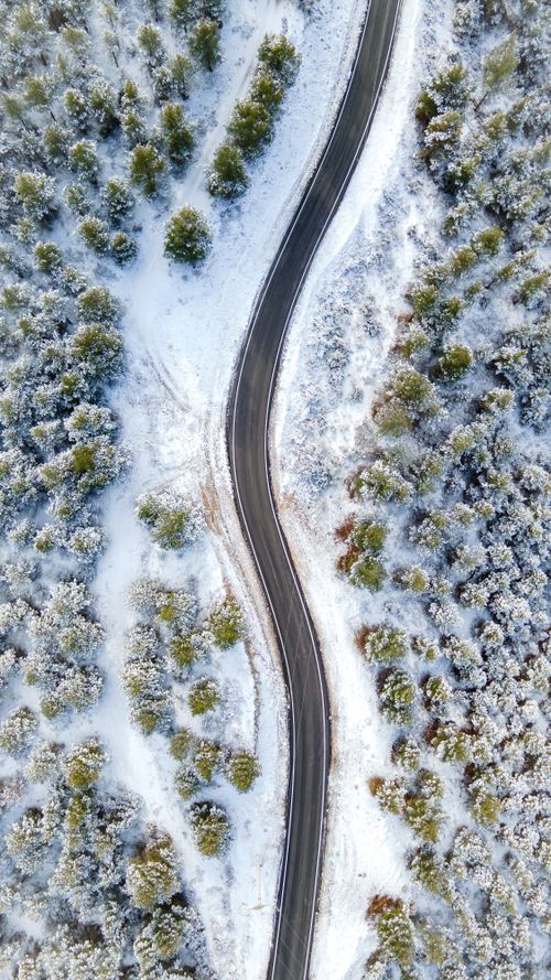 Aerial View of Snowy Winding Road in Winter · Free Stock Photo