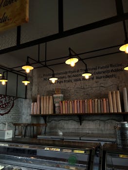 Charming ice cream shop interior featuring vintage lighting and a rustic shelf display.