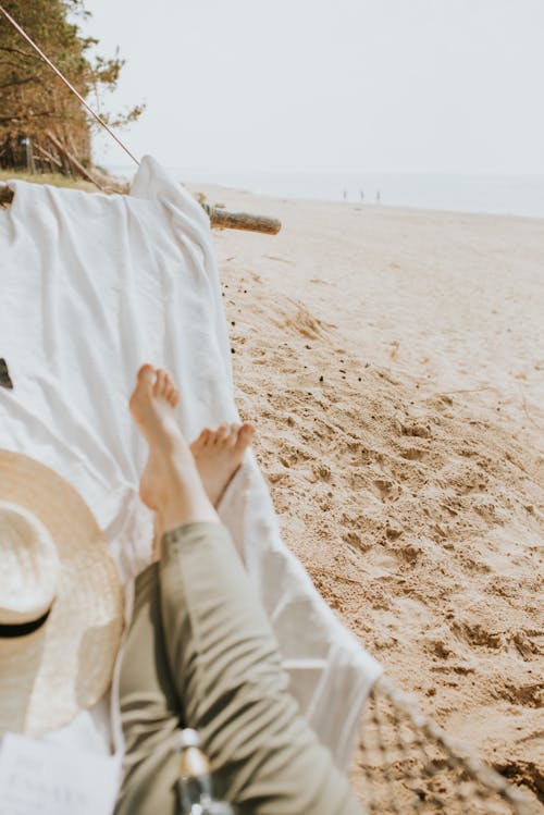 Person Lying in Hammock on the Beach