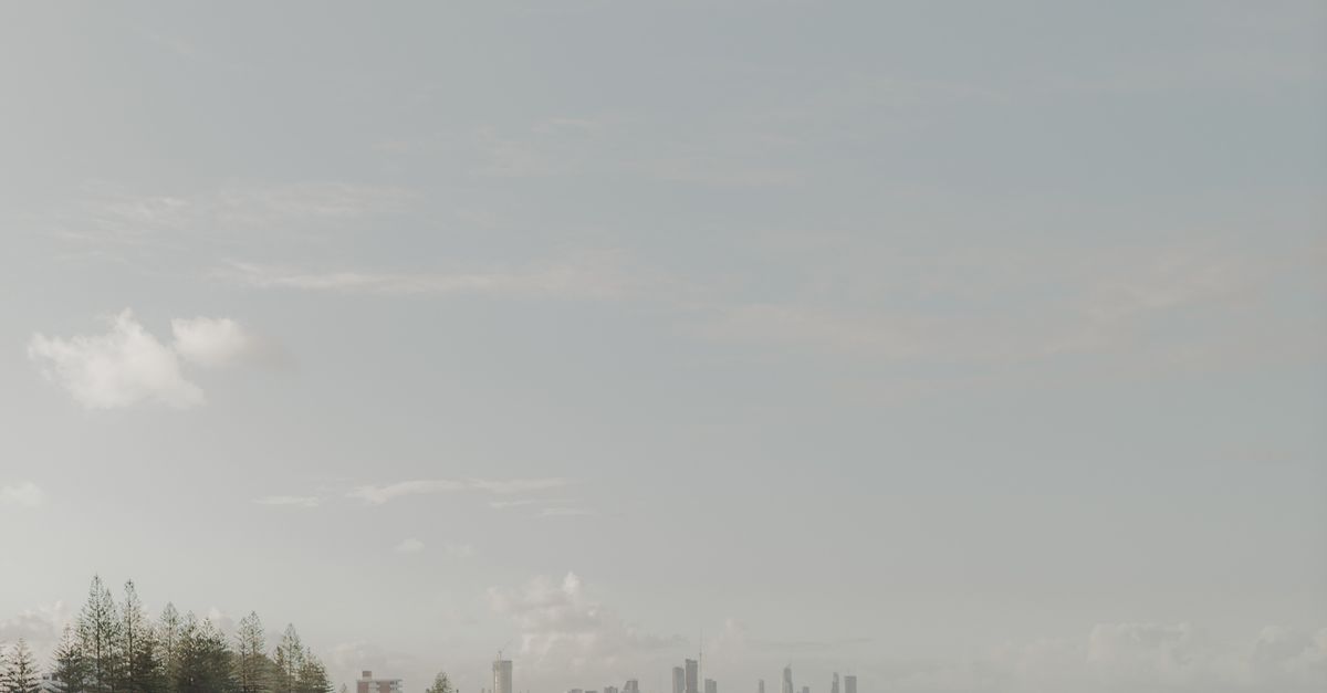 A tranquil morning view of Gold Coast beach with the city skyline in the distance.