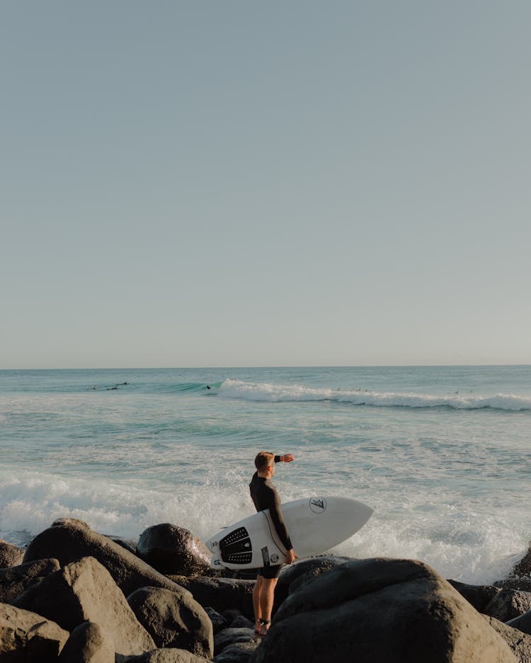 Man With Surfboard On Beach