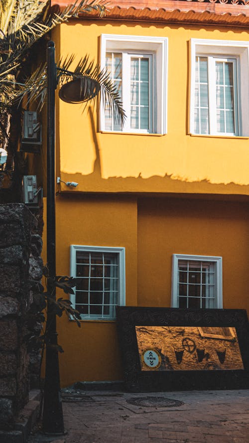 Sunlit Yellow House in Town