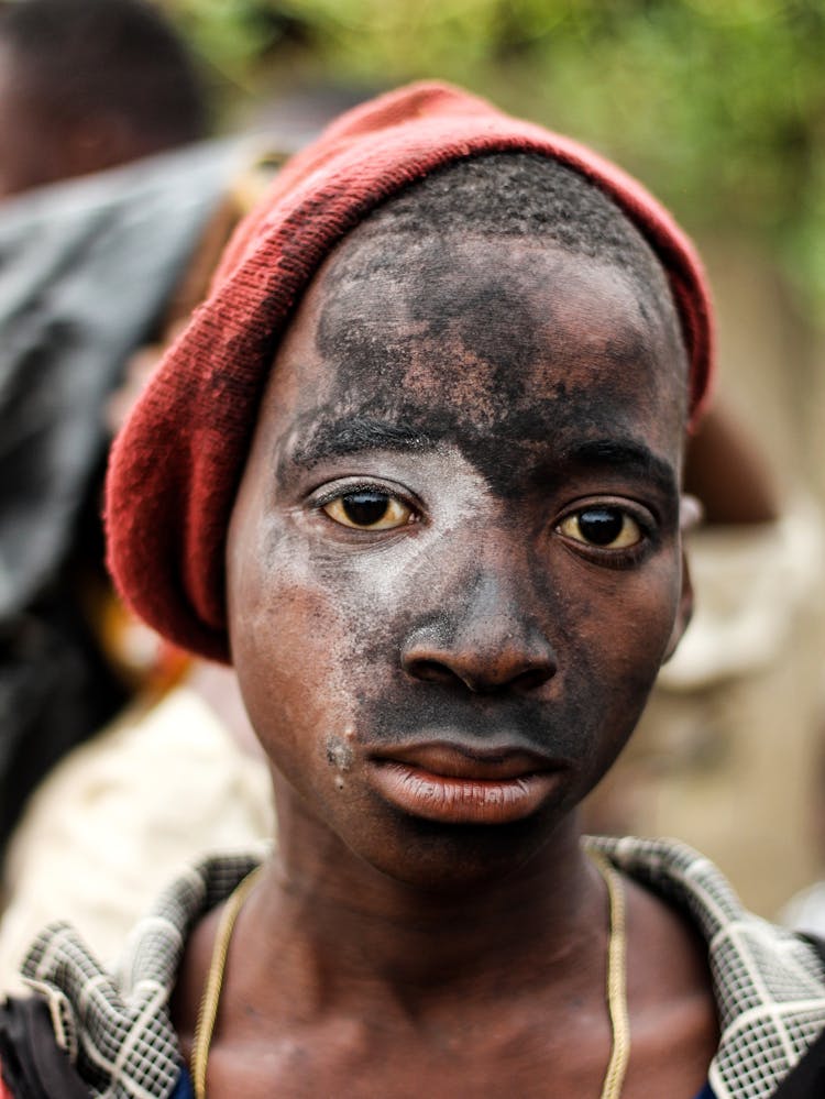 Portrait Of A Teenage Boys Face Covered In Black Dust