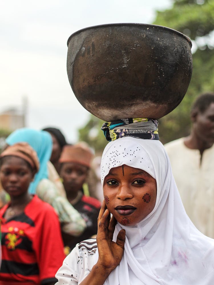 Woman With Pot On Head