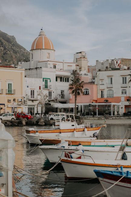 Picturesque view of Forio harbor with colorful buildings and boats on Ischia Island, Italy.