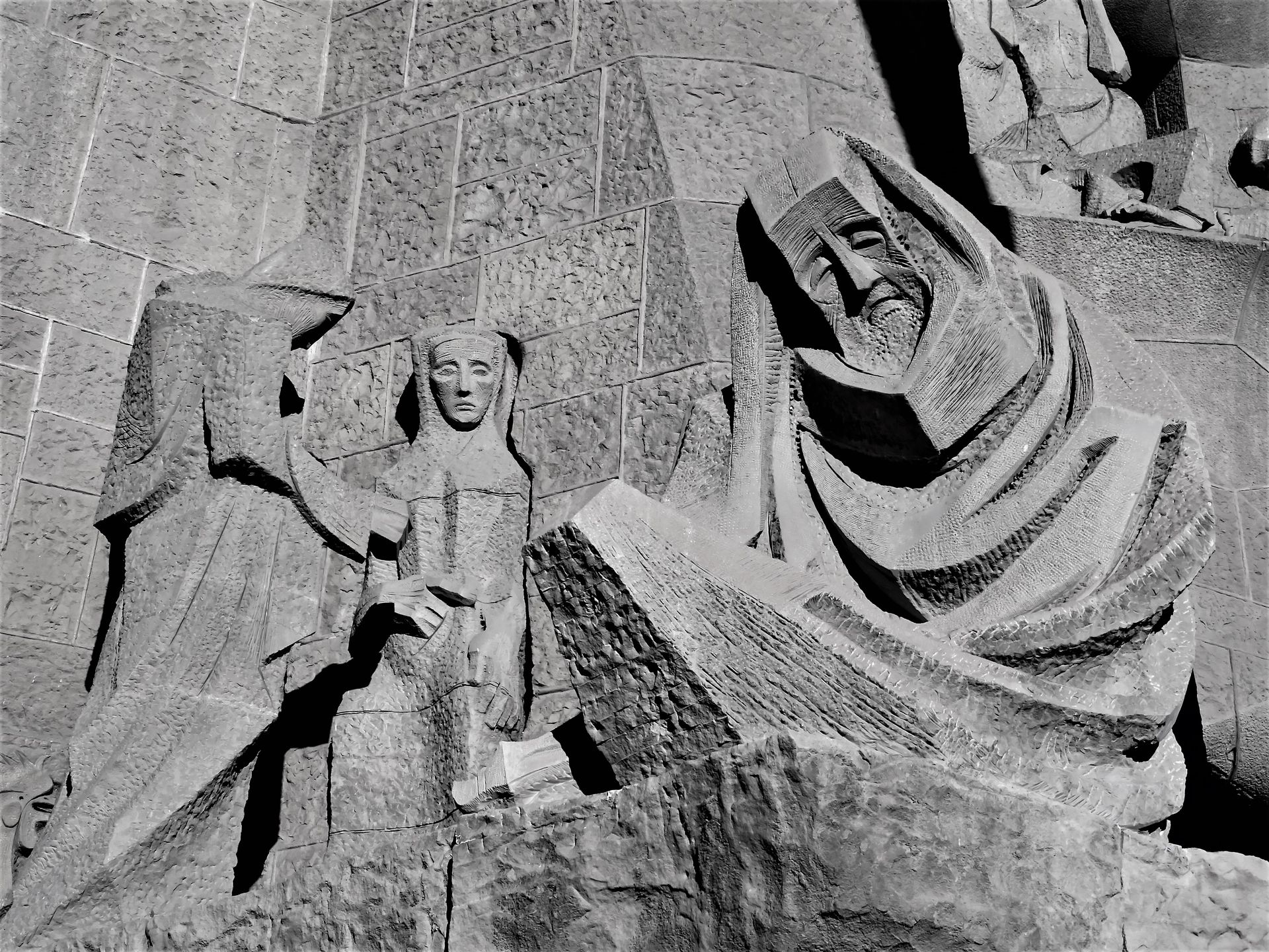 Detailed stone sculptures depicting figures on a renowned historic monument, showcasing intricate craftsmanship.