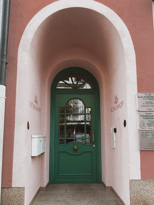 A Arched Doorway with Green Door o a Building in City 