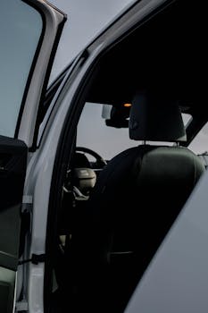 Interior view of a car with the door open, showcasing a modern design and comfort.