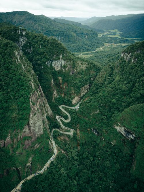 Free Breathtaking aerial view of Serra do Corvo Branco's winding road through lush Brazilian mountains. Stock Photo
