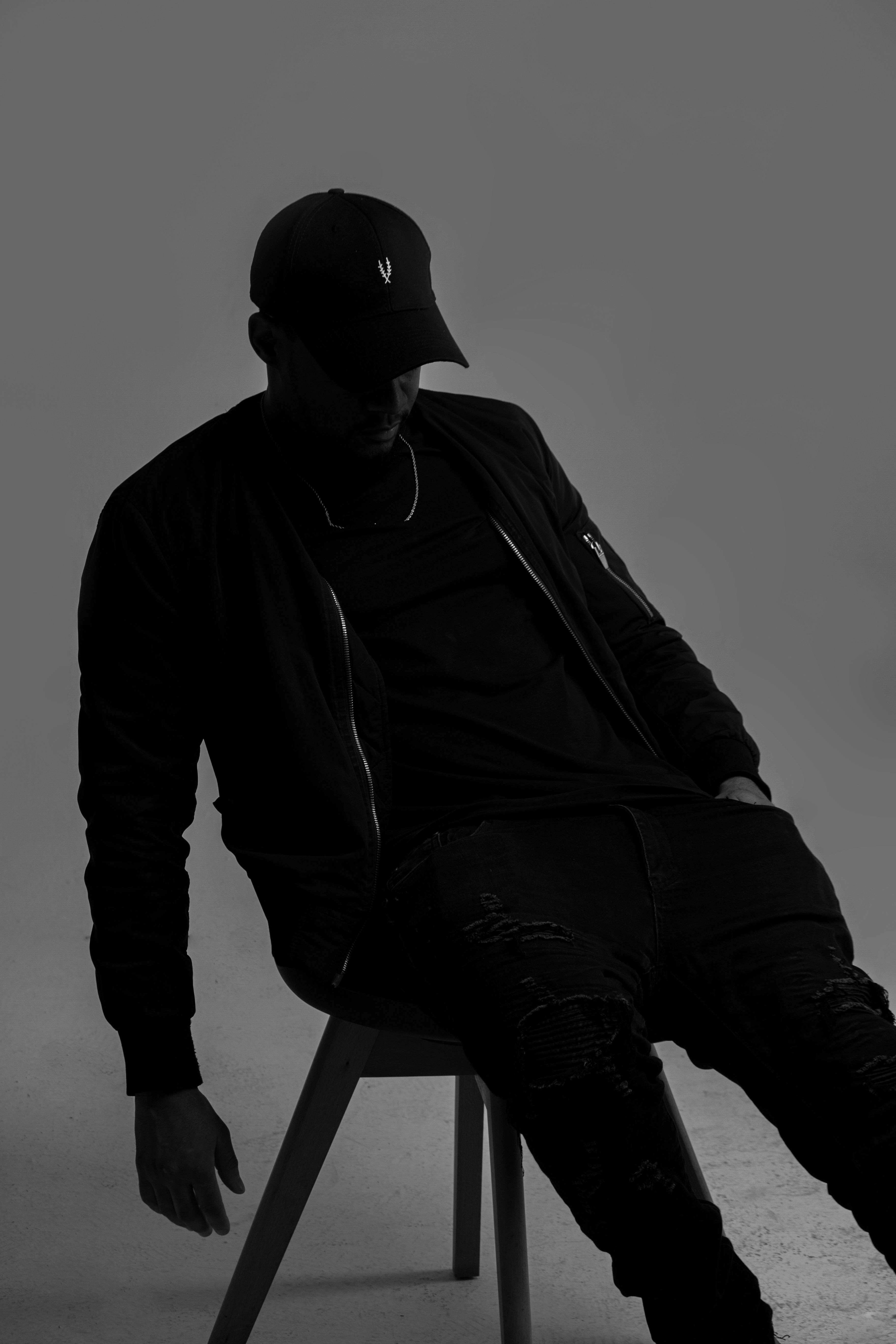 Black and white silhouette of a man in fashion pose during a studio shoot in Angola.