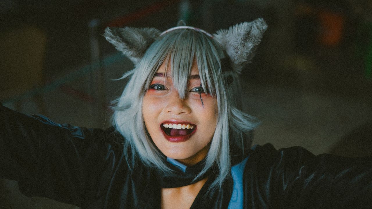 a joyful woman in cosplay costume with animal ears expressing happines