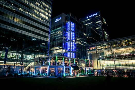 Illuminated corporate buildings in the city center showcasing modern architecture at night.