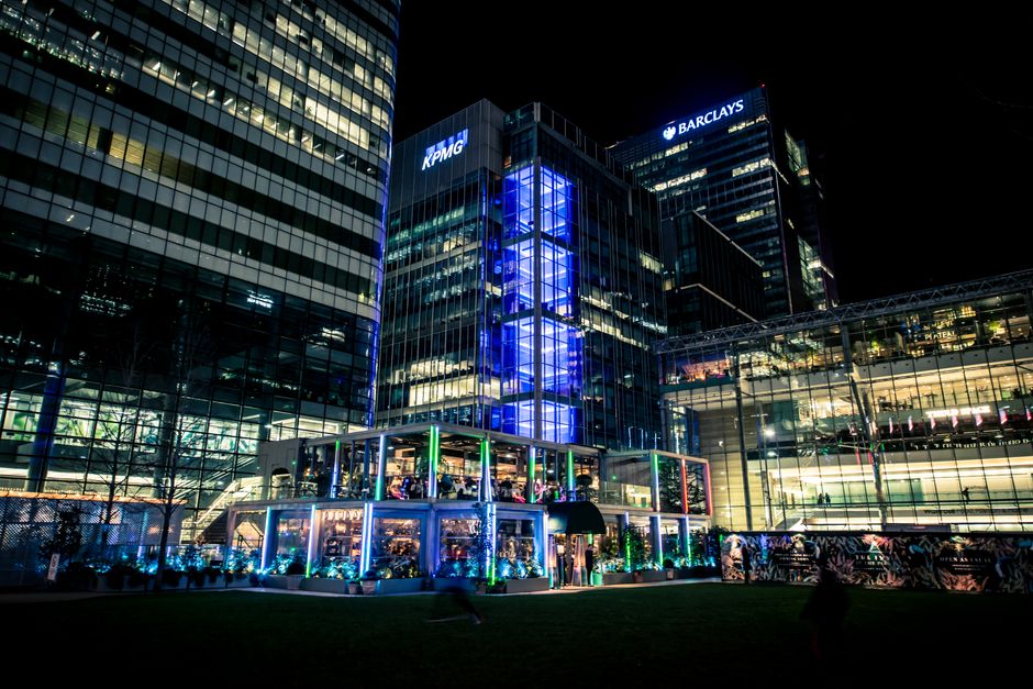 Illuminated corporate buildings in the city center showcasing modern architecture at night.