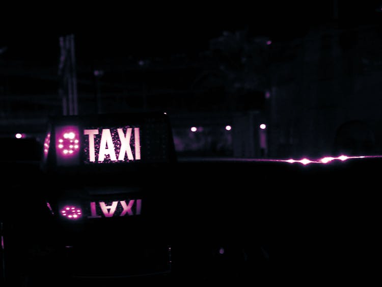 Lighted Taxi Sign At Night