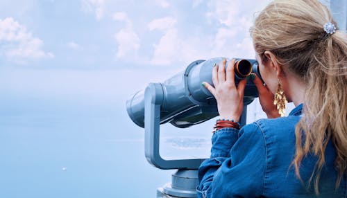 Free Woman in Blue Denim Jacket Holding a Gray Steel Tower Viewer Stock Photo