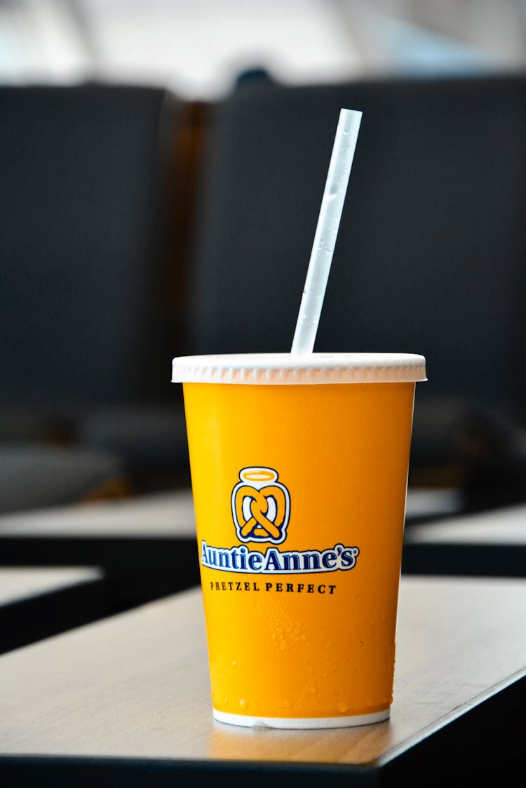 Yellow Disposable Cup With Auntie Annes Pretzel Shop Logo