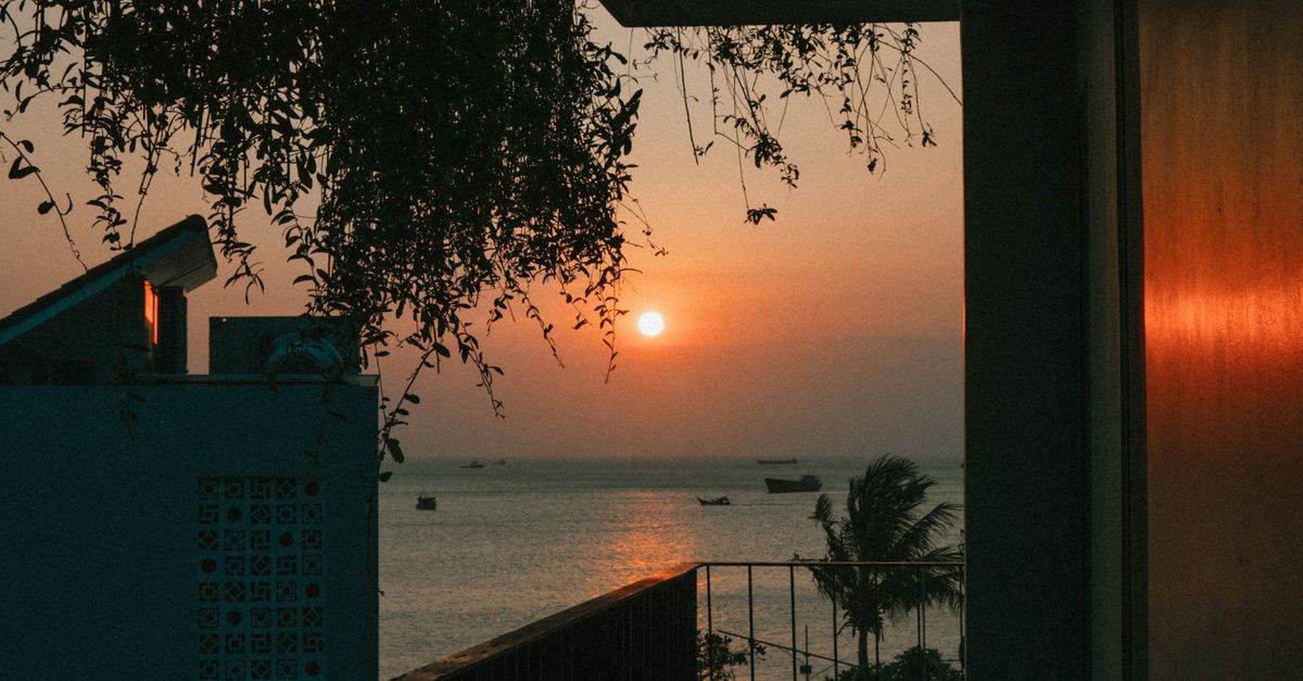 Enjoy the serene beauty of a sunset over the sea from a balcony in Vũng Tàu, Vietnam. Perfect for relaxation.