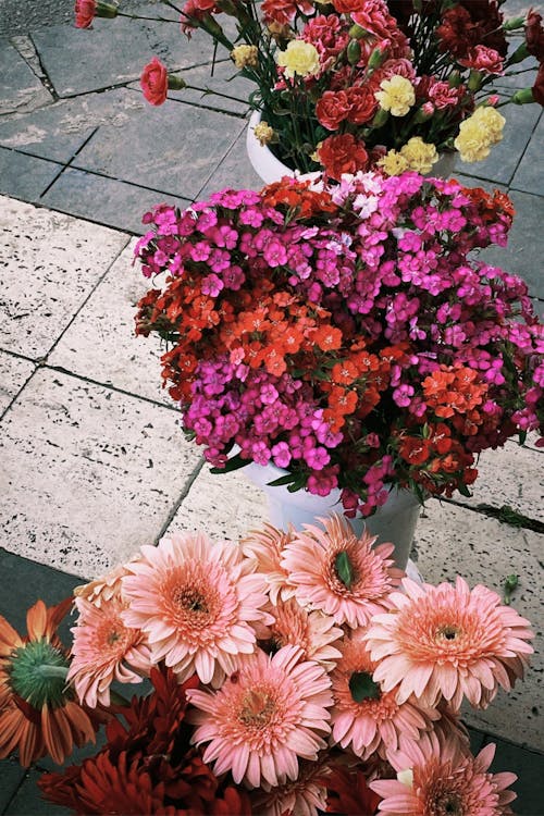 Flower in Vase on Sidewalk