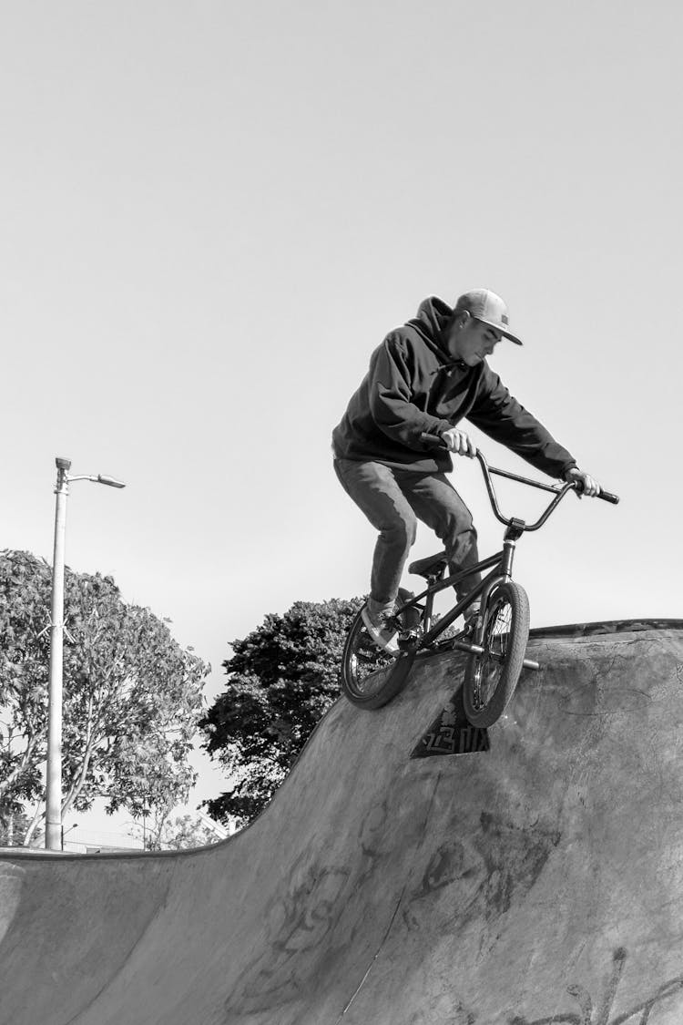 Young Man Riding On A BMX Bike In A Skatepark 