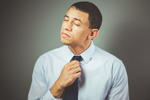 Free Man Arranging His Black Necktie Stock Photo