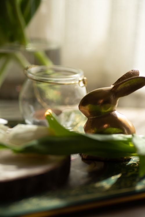 Free Elegant golden bunny figurine with floral accents, perfect for Easter decor. Stock Photo