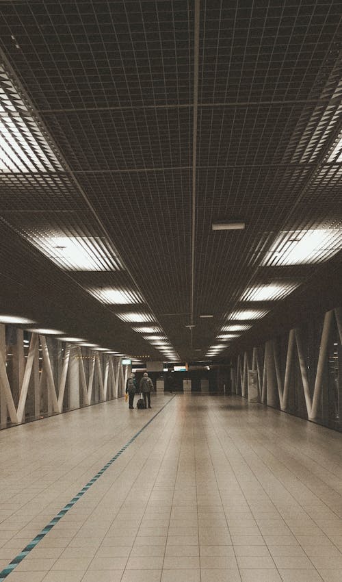 View of People Walking in a Hallway at an Airport