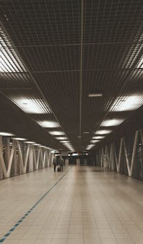 A symmetrical view of a modern corridor at Amsterdam Schiphol Airport, highlighting contemporary architecture.
