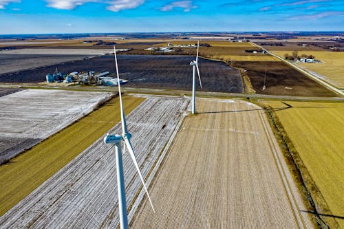 Windmills And Green Grass Field