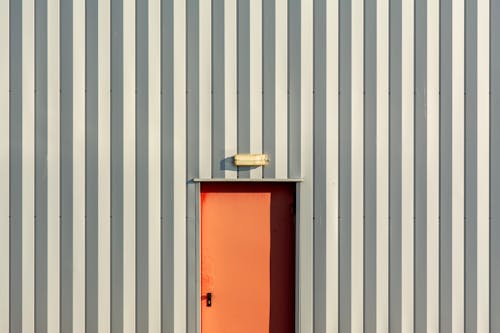 Red Door in a Corrugated Gray Wall