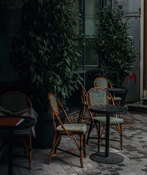 View of Chairs and Tables Standing in the Patio of a Cafe