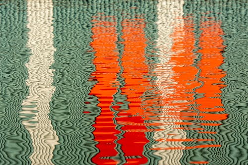 White and Orange Lines Reflecting in the Water Surface