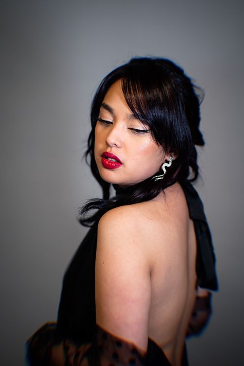 Free Portrait of woman in black dress with red lipstick and elegant earrings. Stock Photo