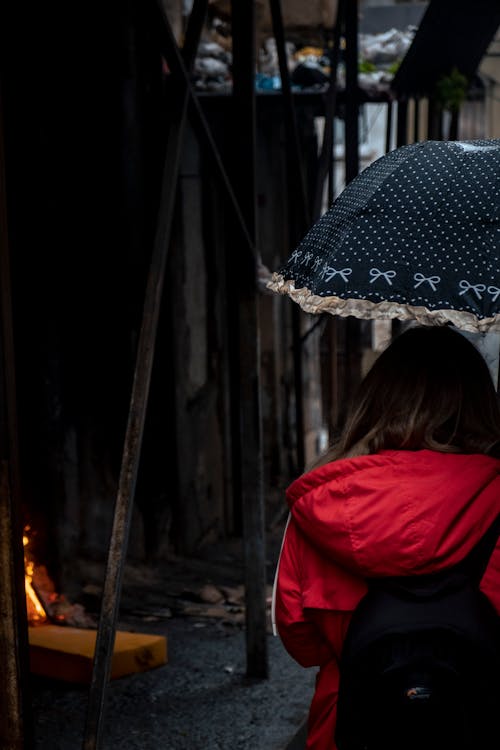 Woman in Jacket Walking with Umbrella