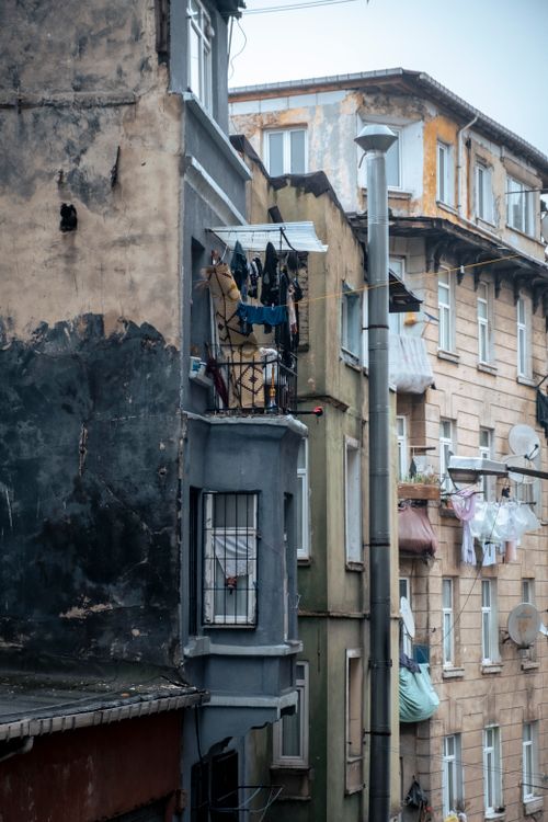 Free Detailed view of urban residential buildings with laundry hanging on balconies. Stock Photo