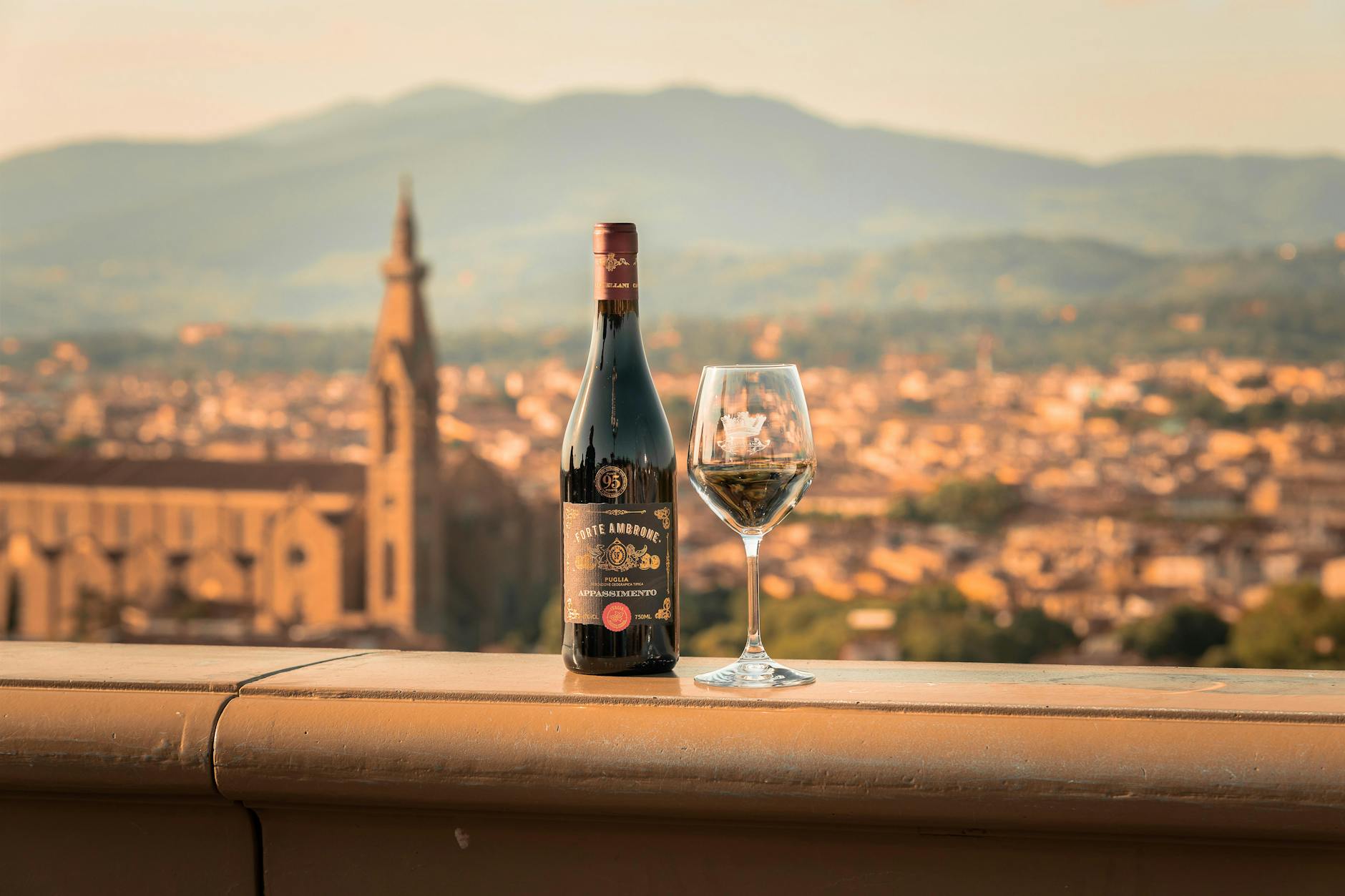 Wine and Glass on Wall in Town in Tuscany