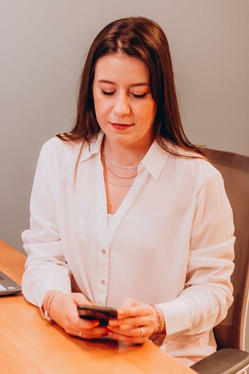 Sitting Woman Looking on Smart Phone