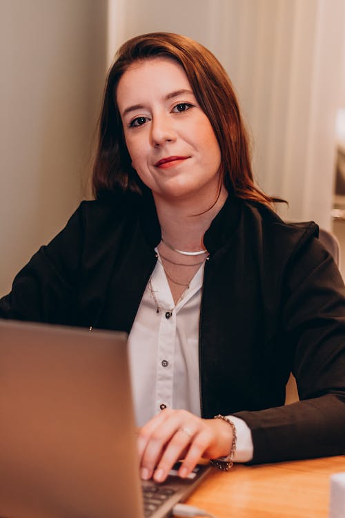 Smiling Woman Sitting at the Computer