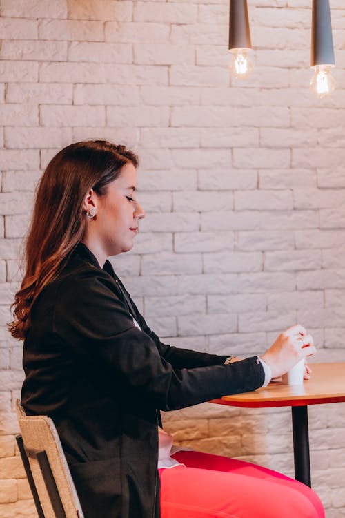 Woman Holding a Disposable Cup