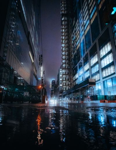 Rain-slicked city street at night, photo by David Gari on Pexels