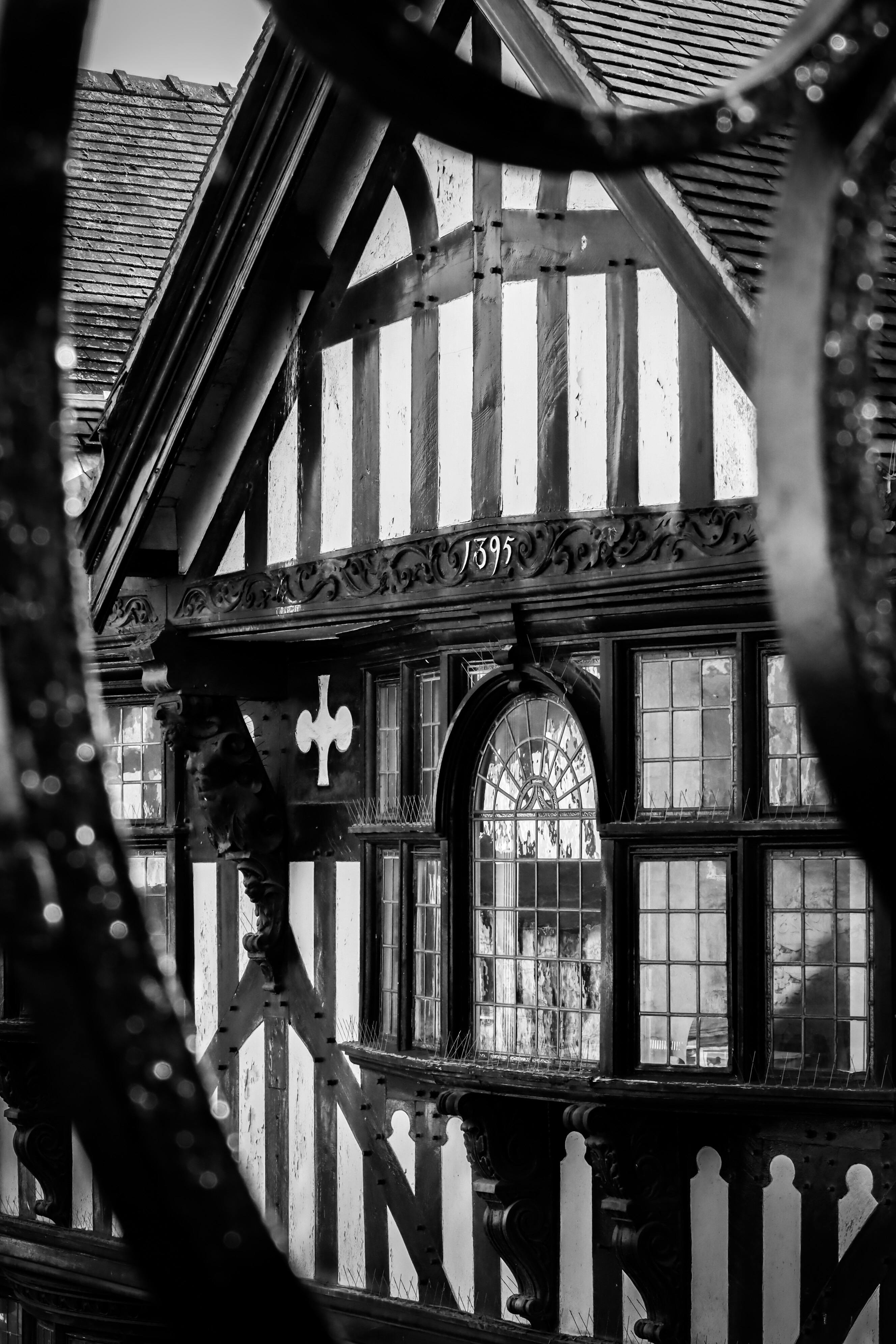 A detailed close-up view of a vintage Tudor-style building façade.