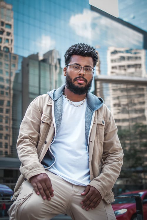 Man Posing in Jacket and Eyeglasses