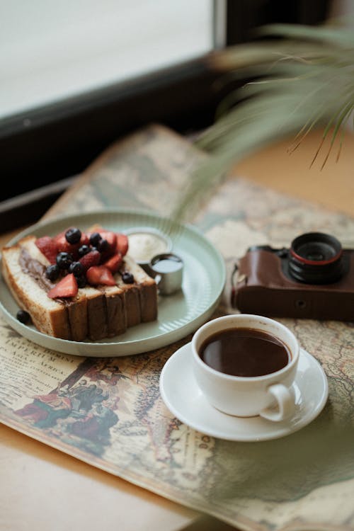 Coffee and Cake on Retro Newspaper on Table