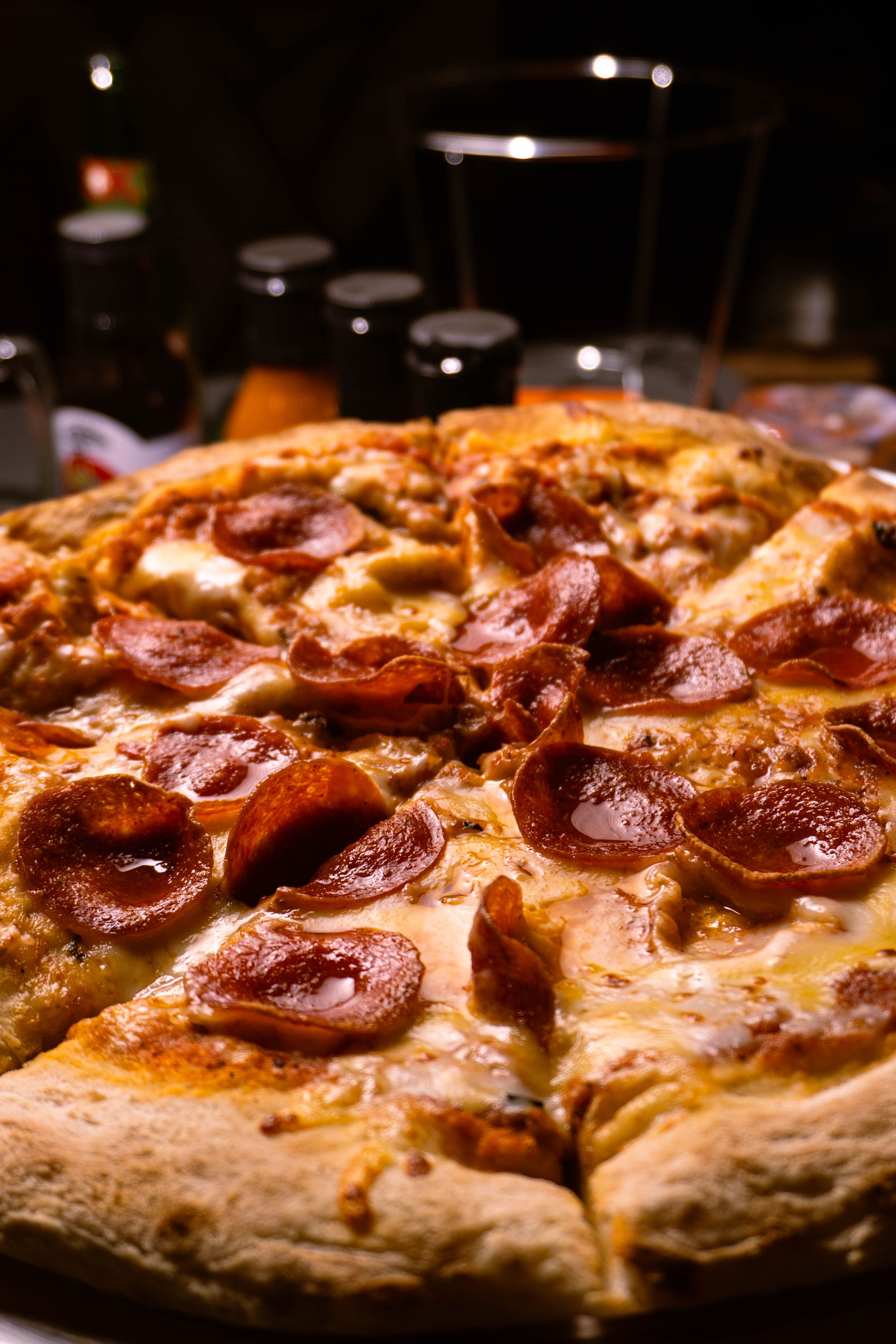 Delicious pepperoni pizza with melted cheese in a cozy restaurant setting.