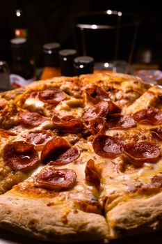 Delicious pepperoni pizza with melted cheese in a cozy restaurant setting.