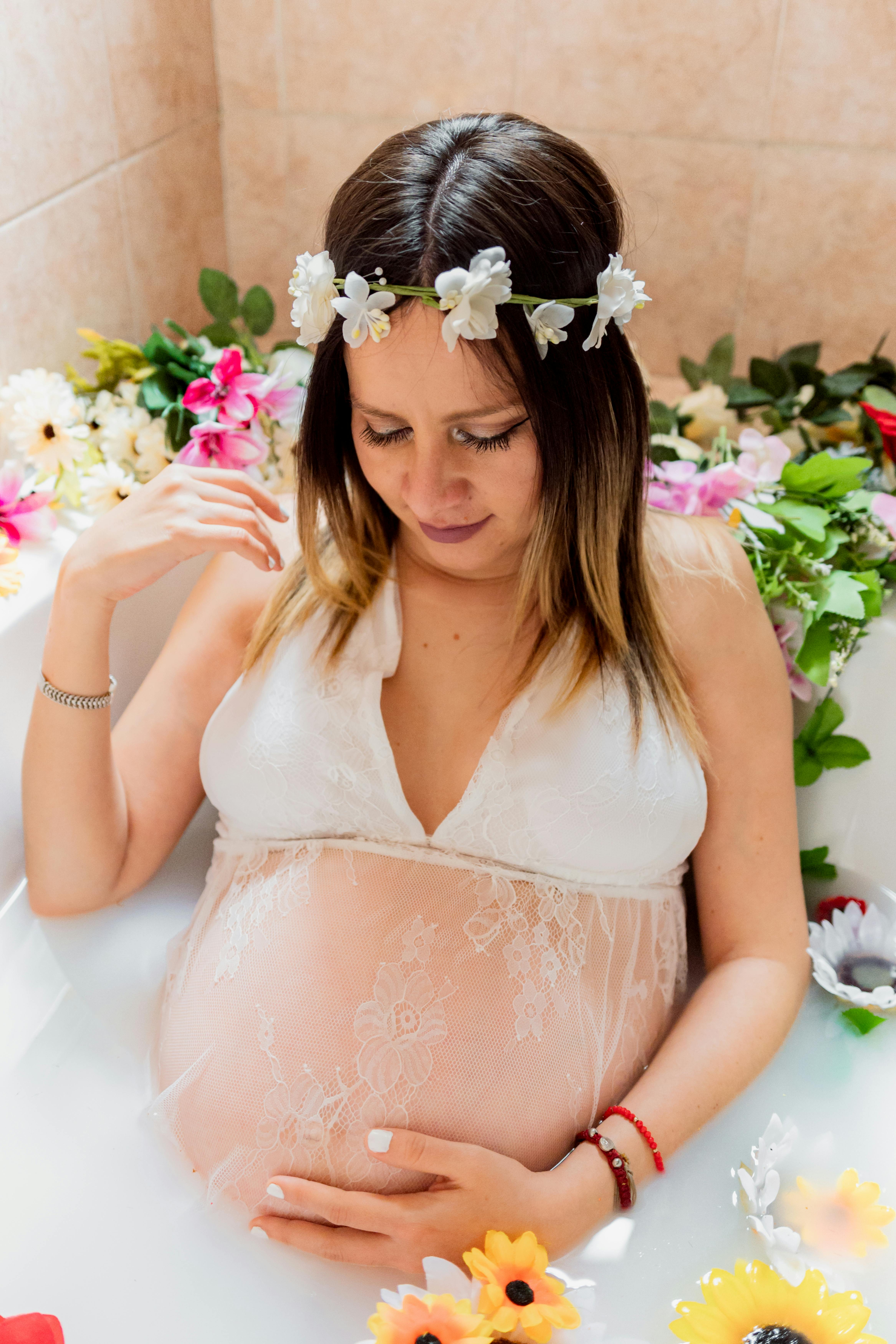 Pregnant Woman Sitting in a Bathtub with Flowers · Free Stock Photo