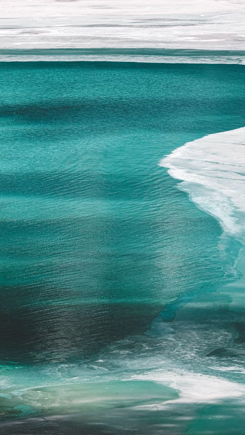 Free A breathtaking aerial view of turquoise ocean waves and sea foam in natural harmony. Stock Photo