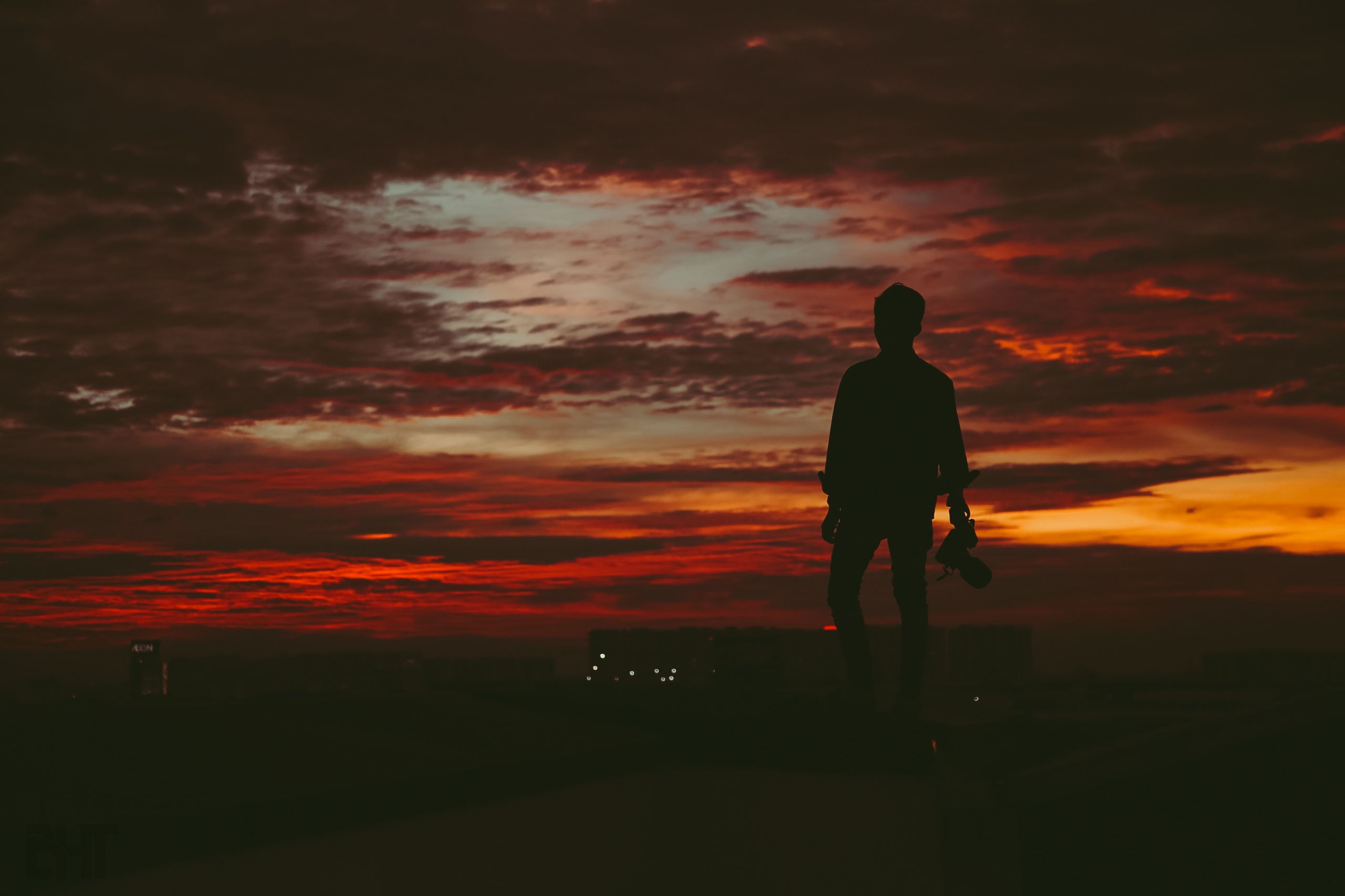 Photographer at dawn capturing Gurugram skyline from a rooftop